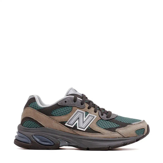 A New Balance 860v2 sneaker in dark green, grey, and tan.