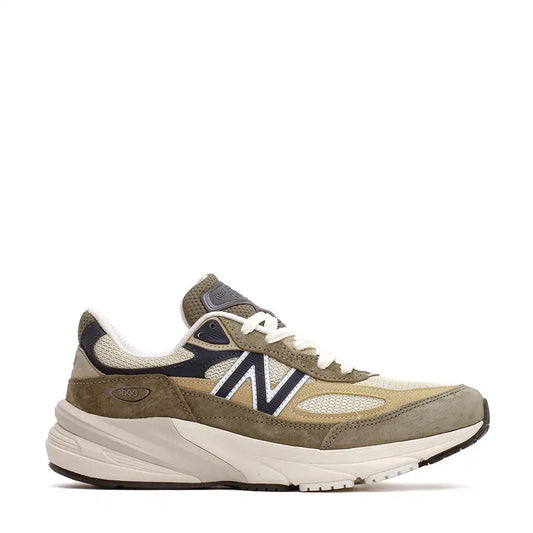 A New Balance 990v6 sneaker in olive green, tan, and cream with dark blue accents and white laces.