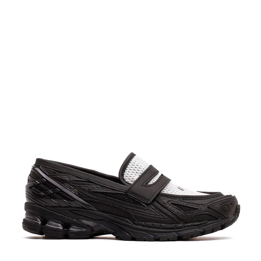 Black and white asics gel-kayano 270 loafer with mesh detailing and a chunky rubber sole.