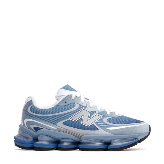 Blue and grey New Balance running shoe with a segmented sole.