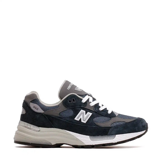 Dark blue and grey New Balance 992 running shoe with white laces and sole.