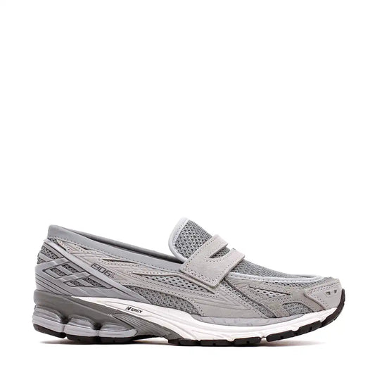 Gray mesh slip-on athletic shoe with a strap closure.