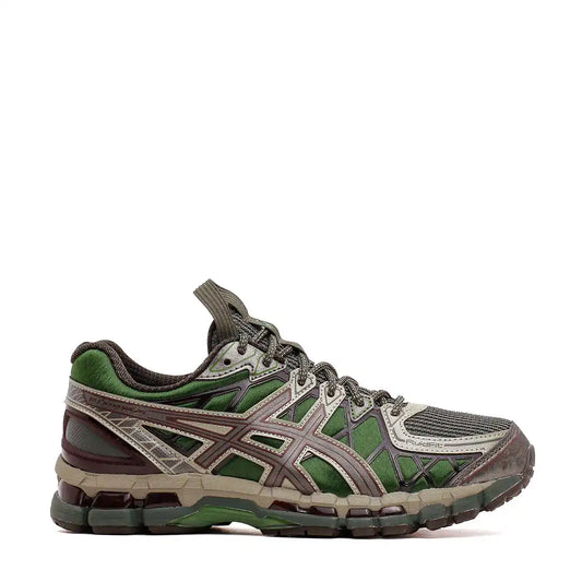 Green and grey ASICS running shoe with a textured sole.