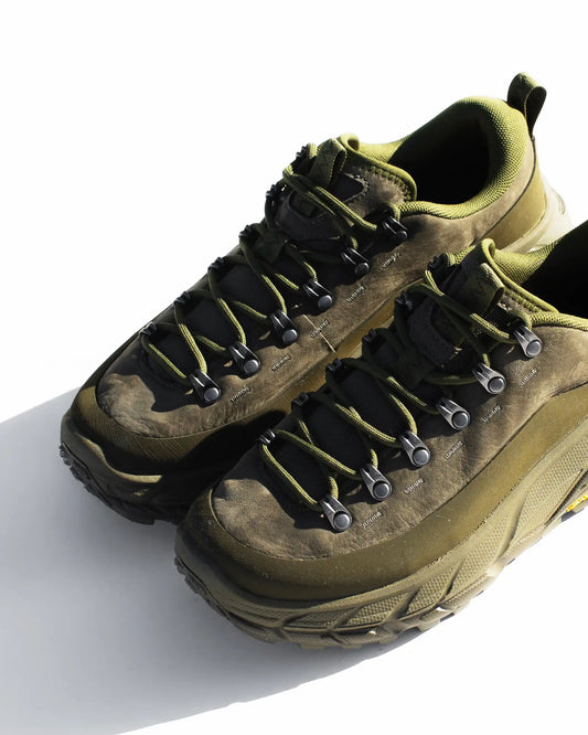 Olive green hiking boot with black laces and rubber sole, designed for outdoor activities.