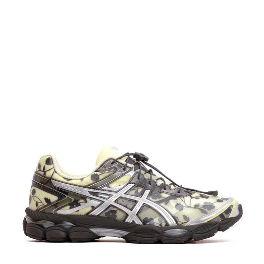 A pair of Asics Gel-Kayano 14 sneakers with a semi-translucent upper featuring a floral or leaf-like pattern in shades of gray and black, silver branding, and a black sole.
