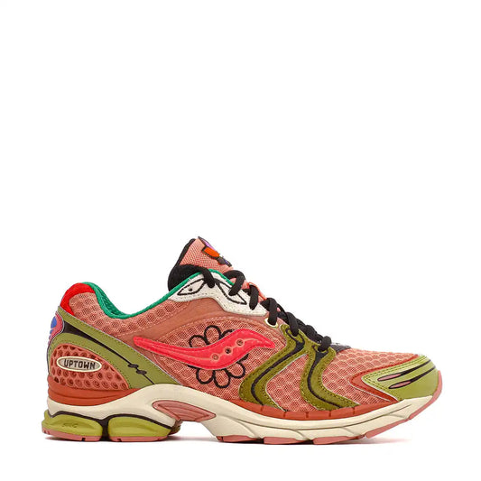 Pink and olive green athletic shoe with black laces and a unique floral design.
