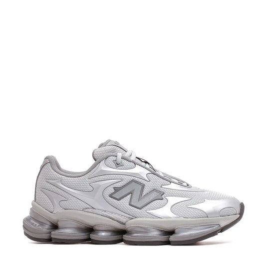 Silver new balance sneaker with a mesh upper and bold, flame-like design accents.