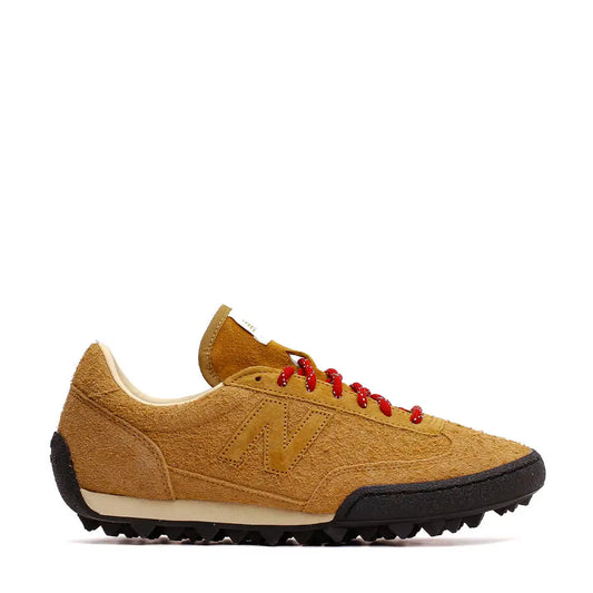 Tan suede new balance 547 sneaker with red laces and a black rubber outsole.